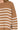 Close-up of ribbed texture and exposed seam detail on camel stripe knit