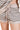 Close-up of taupe ribbed stripes on shorts showing knit texture and detail