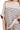 Close-up of taupe ribbed stripes on folded sleeve top showing knit texture and detail