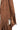 Close-up of mocha suede texture and fringe detail on tailored blazer