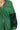 Close-up of black sequin sleeve and green terry fabric contrast on hoodie