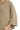 Close-up view of taupe textured knit fabric with visible rib surface and soft texture.