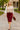 Model walking in sand beige tie front cropped sweater vest with pencil skirt, city park daytime.