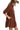 Side view of red-brown dress showing tiered layers and sleeve volume