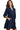 Side view of navy corduroy mini dress showing layered skirt and puff sleeve detail