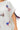Close up of cotton tee with sequin ribbon in American flag design and tassel detail on hem