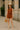 Sleeveless knit set styled simply with nude block-heel sandals, basket bag, and beige hat