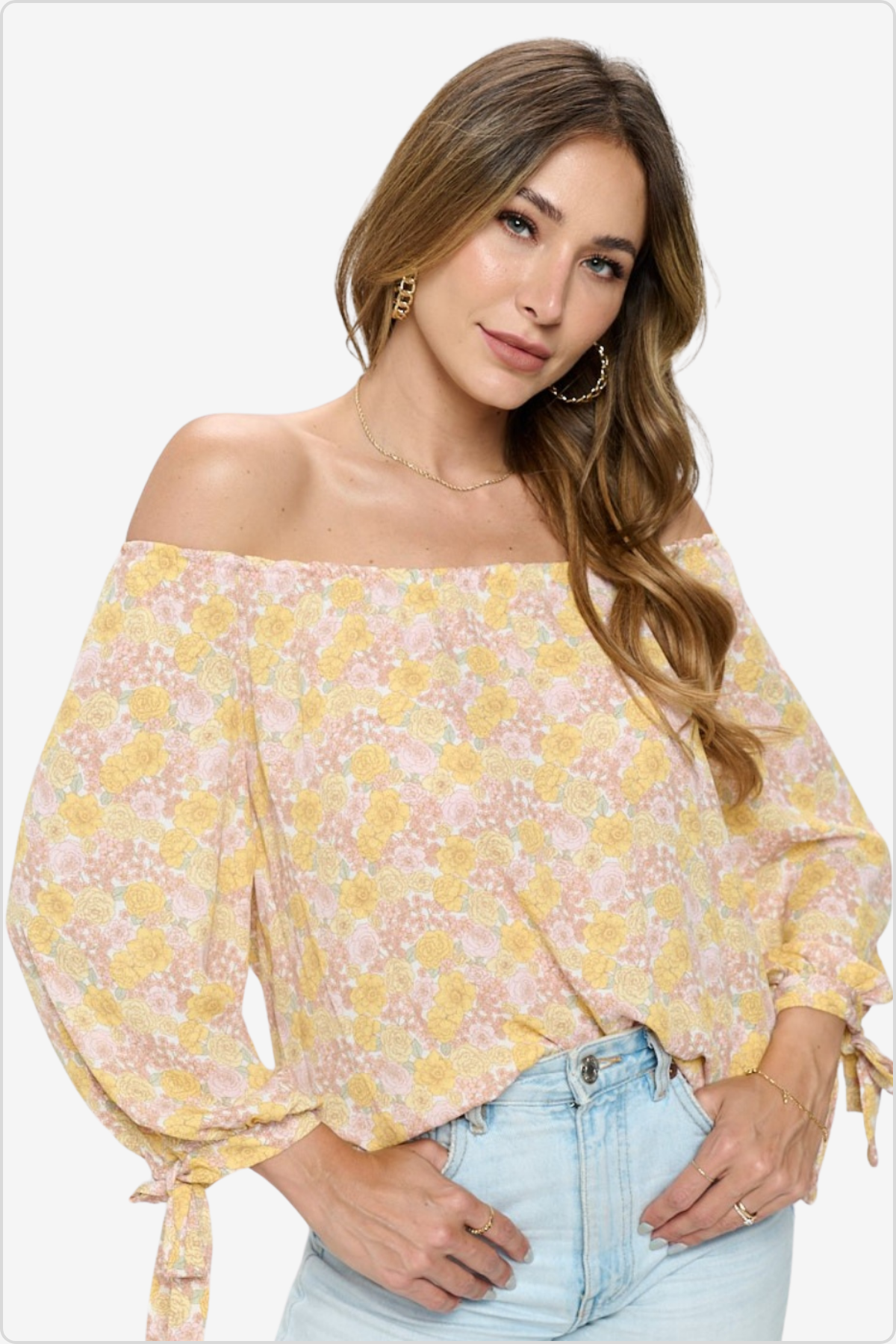 Elegant off-shoulder blouse with yellow and pink floral pattern, featuring tie-up sleeves and a relaxed fit, ideal for spring and summer fashion.