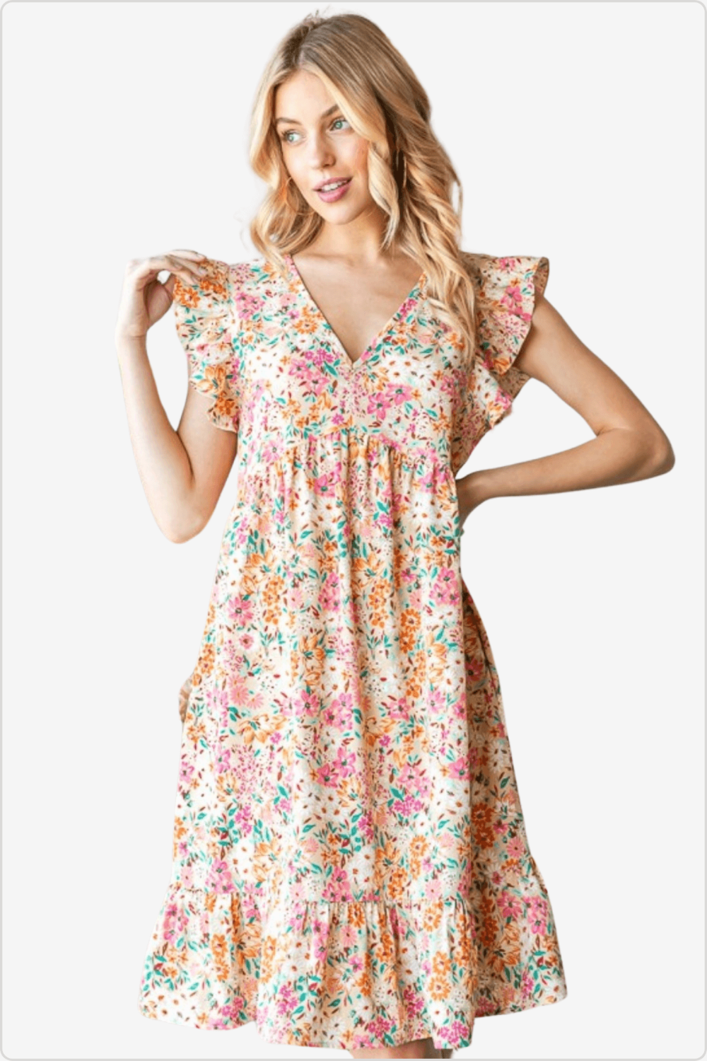 Blonde woman modeling a short floral dress with frill sleeves, ideal for summer casual wear.