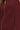 Close-up view of maroon vest fabric showing zip detail and pocket stitching.