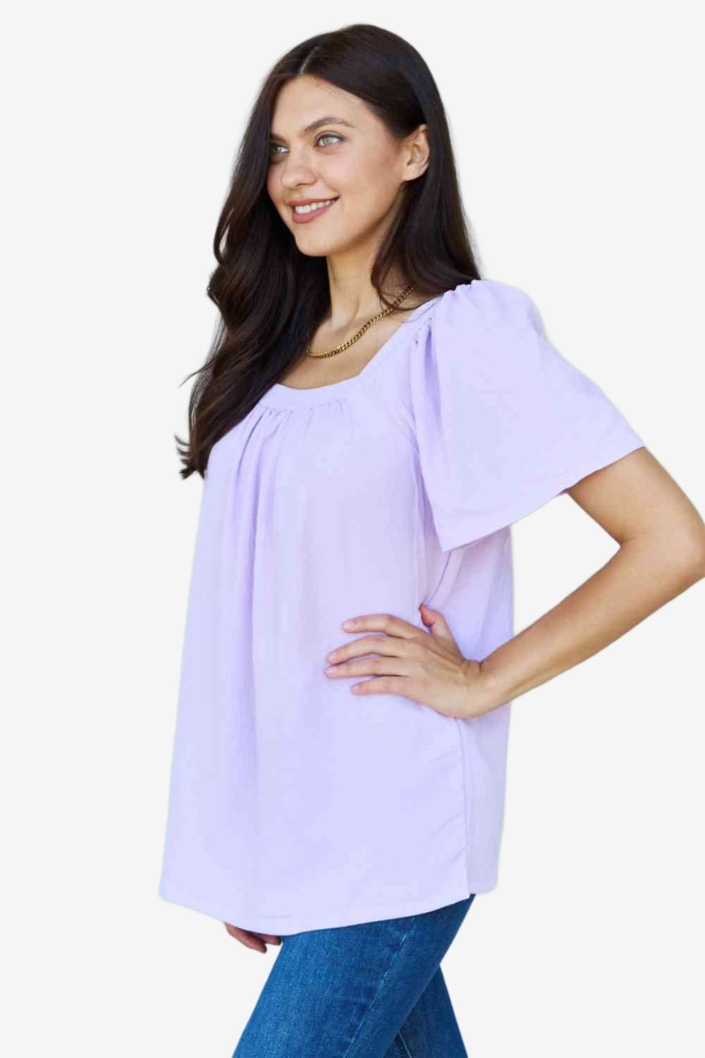 Side view of elegant square neck blouse, showcasing puff sleeves.