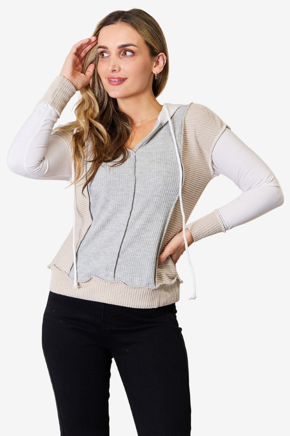 Chic color block hoodie with exposed seams and a drawstring, front view.