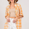 Classic plaid button-up shirt with side slits, front view.