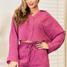 Trendy buttoned long-sleeve top and shorts set for summer, front view.