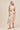 Woman wearing a floral dress on a beige background