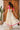 Back view of cream floral maxi dress with tiered ruffles and soft volume