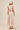 Model back view with tie-back crop top and cascading skirt tiers