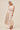 Woman wearing a floral dress on a beige background
