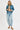 Woman wearing a denim jacket and jeans on a white background