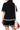 Back view of black crinkled shirt and shorts with breezy silhouette.