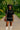Black woven two-piece set for women with white boots and cat-eye sunglasses in summer park.