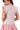 Back view of blush pink knit sweater for women with feminine, relaxed fit.