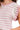 Close-up of ruffle and openwork knit details in blush striped sweater.