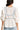 Back view of women's cactus blouse with fitted bodice and bow detail.