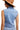 Back view of denim vest displaying its sleek and timeless silhouette.