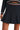 Close-up of cable-knit texture and pleated skirt in navy.