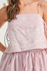 Close-up of lace and embroidery details on top, showing texture and fine stitching.