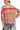 Back view of women's neon sweater with bold knit textures and relaxed drape