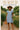 Ruffle sleeve dress styled with straw hat, tan sandals, and wicker bag in floral garden
