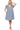 Model in navy ruffle dress styled with nude heels for a polished daytime look