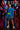 Woman in blue blouse with neon belt bag and denim skirt on neon-lit street
