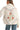 Back view of quilted jacket with multi-color floral embroidery detail.