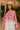Pink and white crochet top with flower detail – styled with a sun hat and skirt