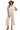 Women's cream wide leg jumpsuit with button details, front view showcasing its relaxed fit and minimalist style.