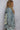 Side view of oversized denim jacket with drawstring hood and faded wash 