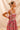 Close-up of pink floral print with ribbon straps and ruffle detail