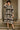 Model posing in abstract floral print midi dress with black heels, stone columns, daylight.