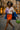 Lavender checker top with orange mini skirt, blue blazer and green bag for color clash outfit