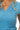 Close-up of pearl embellished knit top with chevron detail and ribbed texture