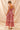  Model back view of smocked floral dress with ribbon tie detail
