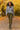 Walking in chenille knit sweater with ribbed skirt and boots, autumn park with golden leaves