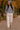 Walking in chenille knit sweater with joggers and sneakers, autumn city park with trees
