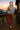 Standing on cabin deck in chenille knit sweater with corduroy pants and boots, mountain sunset
