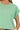 Close-up of sleeve roll, round neckline, and cotton fabric texture.