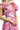 Close-up of floral fabric with ruffle detail at neckline.