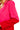 Close-up of fuchsia and red colorblock detail with peak lapel collar